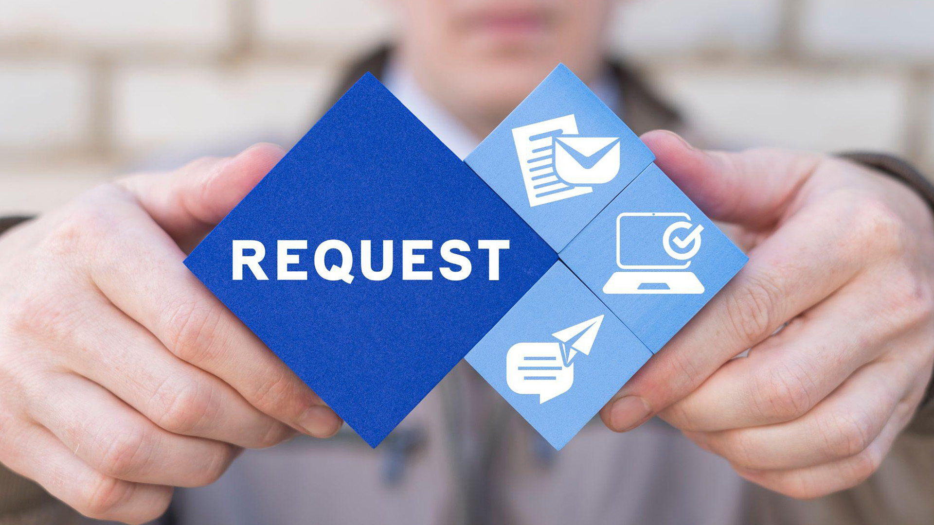 Business professional holding blue blocks labeled ‘Request’ with icons for email and documents, symbolizing how to request a certificate of insurance (COI) from vendors